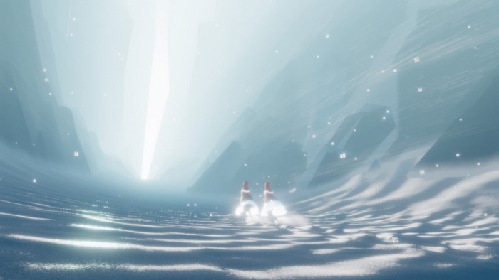 Two figures in red and white robes walk through a snowy landscape in Journey