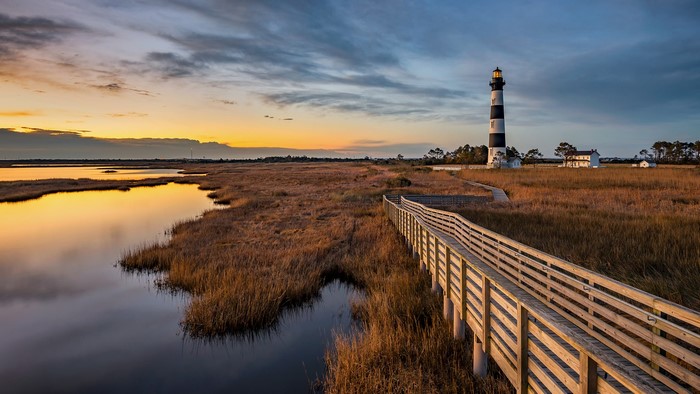 Bodie Island Lighthouse at sunset with wooden walkway