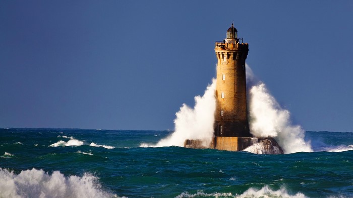 Phare du Four lighthouse in Brittany, France during a storm