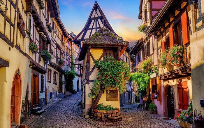 Half-timbered houses on a cobblestone street in Eguisheim, France