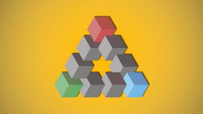 Impossible triangle of colorful cubes on yellow background