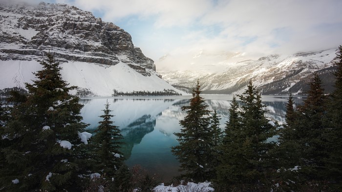 Winter landscape with snow-covered mountains and lake