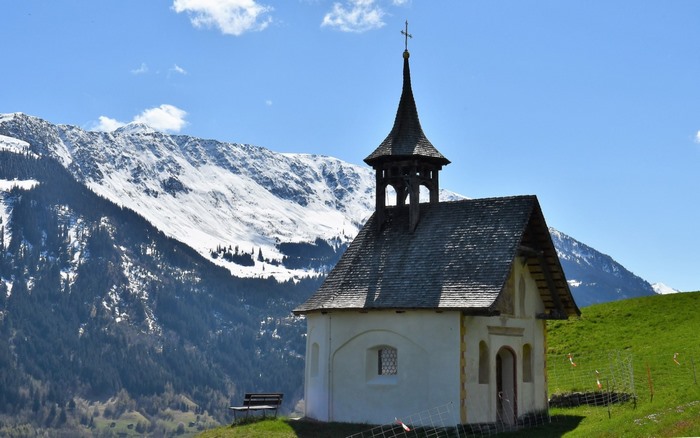 Chapel in the Alps with Snow-Capped Mountains