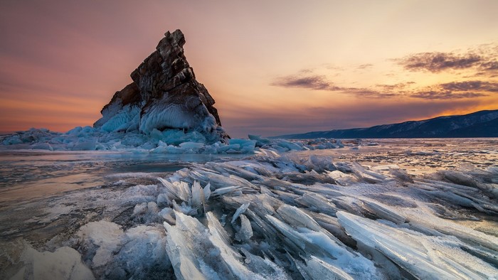 Frozen Lake Baikal with Rock Formation at Sunset