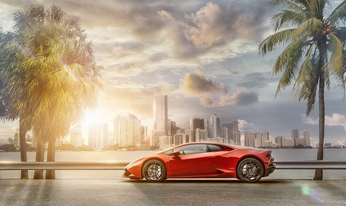 Red Lamborghini Huracan in a Cityscape with Palm Trees