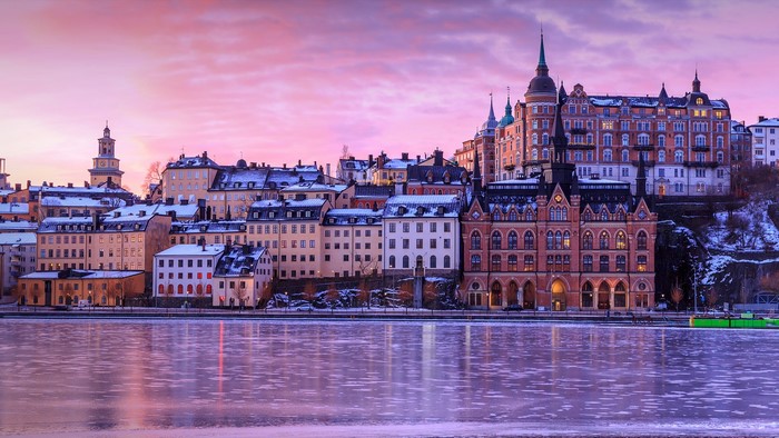 Stockholm cityscape with frozen lake at sunset