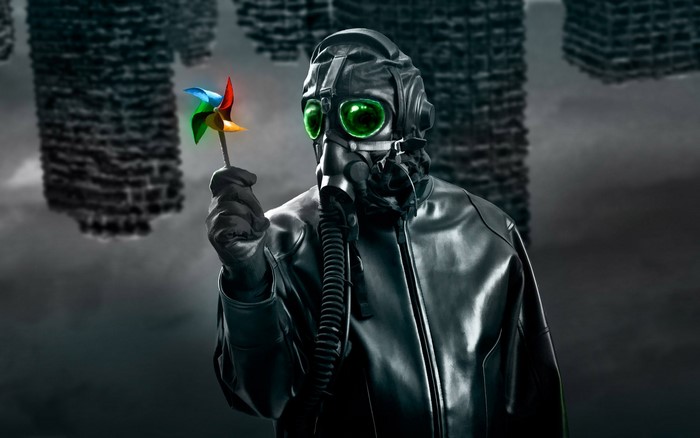 Man in gas mask holding a pinwheel in apocalyptic city