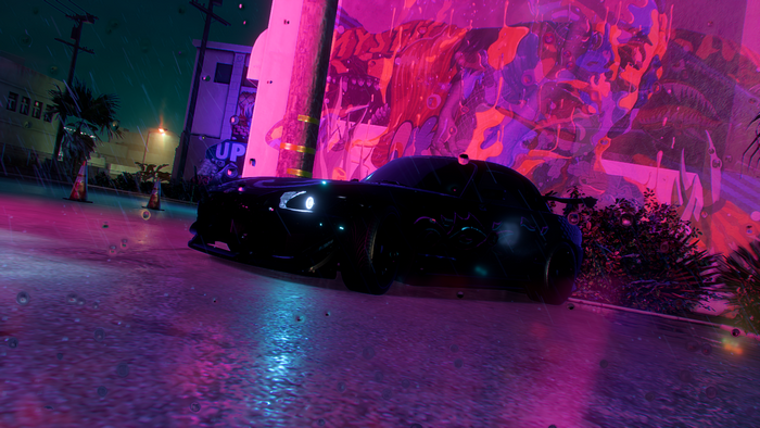 Black Honda S2000 with neon graffiti in the rain