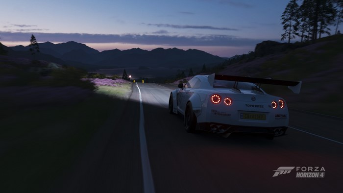 Nissan GTR driving on a road in Forza Horizon 4 at dusk