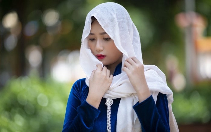 Vietnamese girl in a blue dress and white hijab