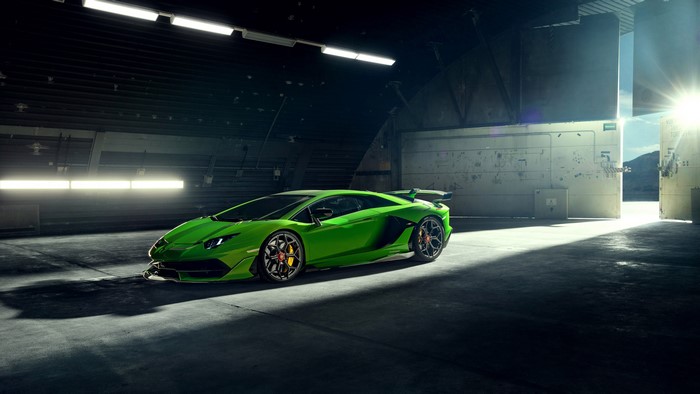 Green Lamborghini Aventador SVJ in a hangar