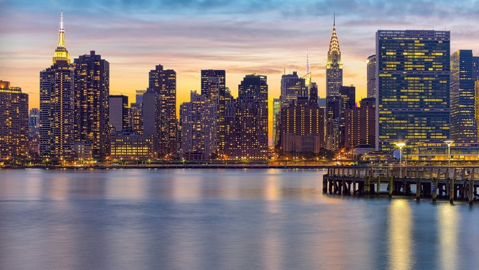 New York City skyline at sunset with a pier