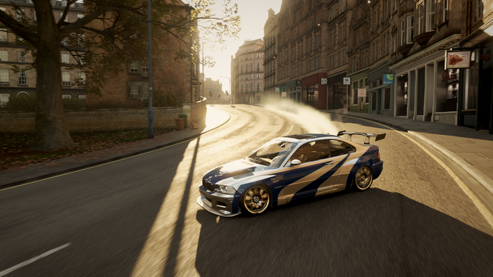 BMW M3 E46 drifting on a city street at sunset