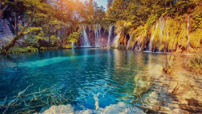 Waterfalls and clear turquoise water at Plitvice Lakes National Park, Croatia