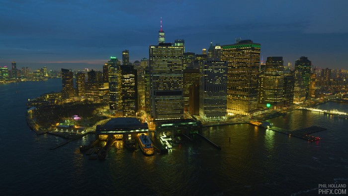 New York City skyline at night with skyscrapers and water