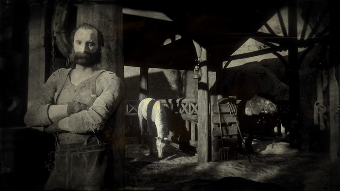 Man in barn with horses in Red Dead Redemption 2