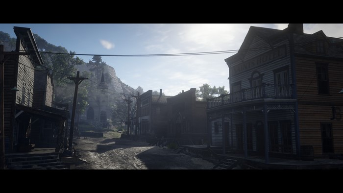 Red Dead Redemption 2 town street with mountains