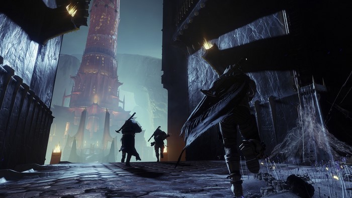 Guardians walking towards a tower in Destiny 2