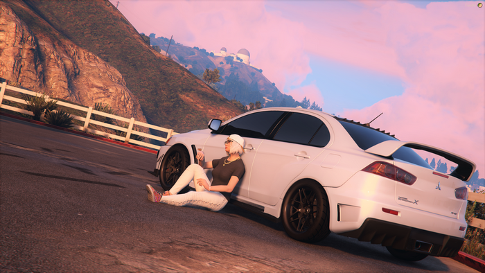 Woman leaning on Mitsubishi Lancer Evo X in Grand Theft Auto V