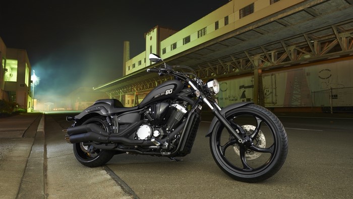 Black Yamaha motorcycle parked on a city street at night