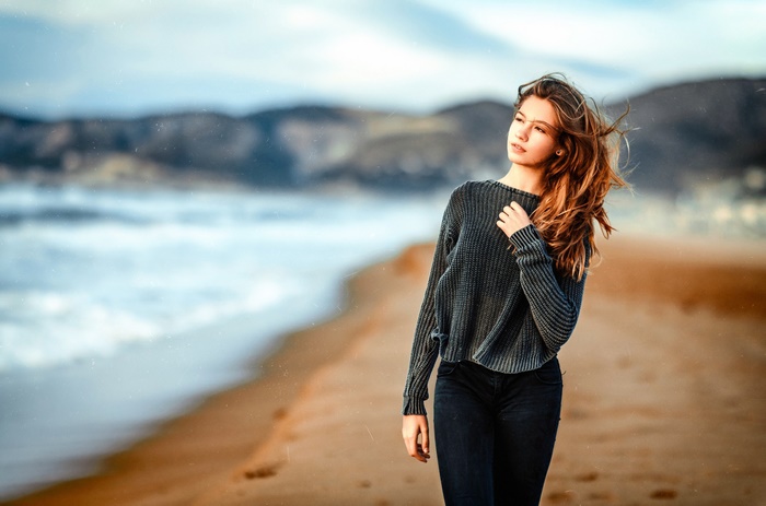 Young woman walking on a beach
