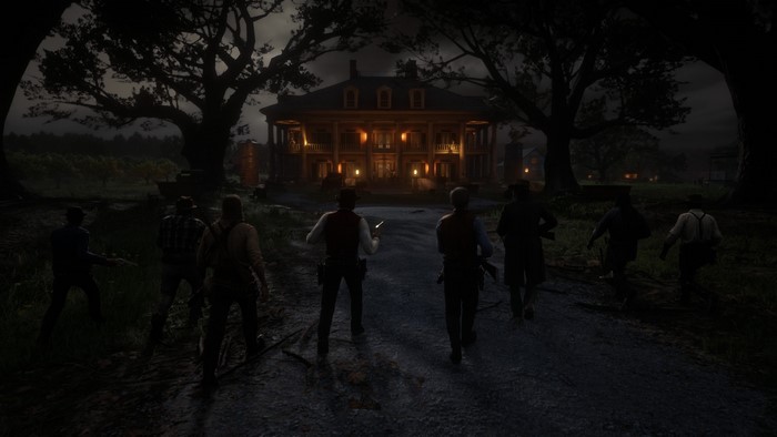 Group of men approaching a large house at night in Red Dead Redemption 2