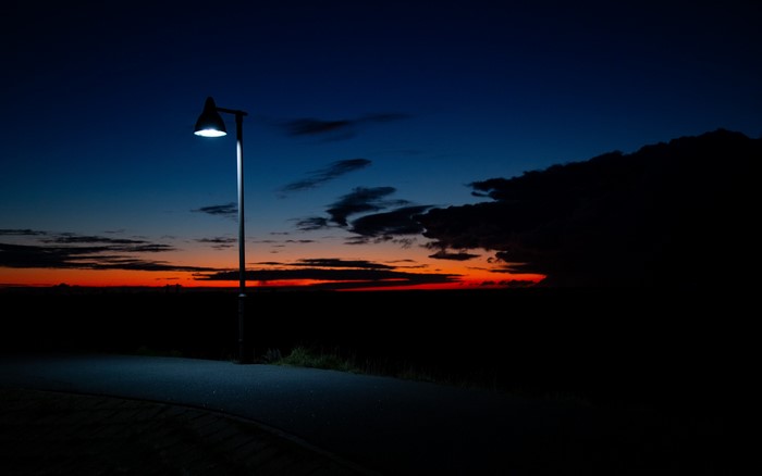 Street light at sunset with dark clouds