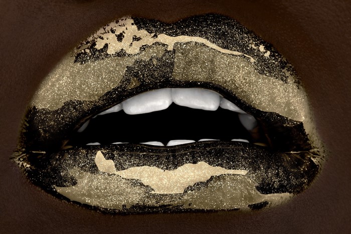 Close-up of lips with gold glitter makeup