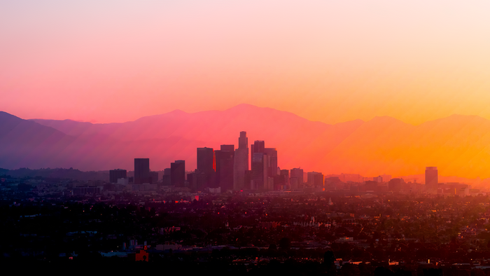 4K Los Angeles cityscape at sunset with mountains