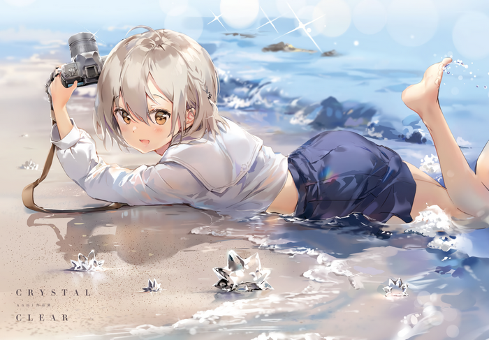 Girl with camera on the beach