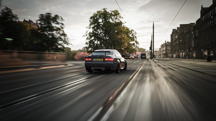 BMW M3 GTS driving on a wet city street in Forza Horizon 4