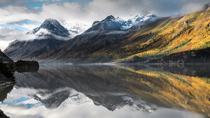 Mountains reflected in Rakwa Tso lake, China