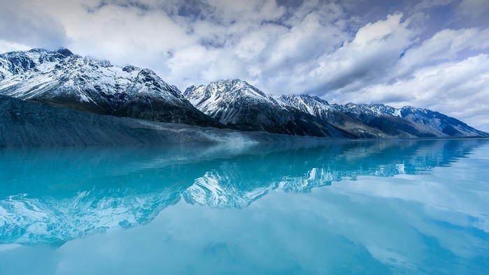 Snowy mountains reflected in Tasman Lake, New Zealand