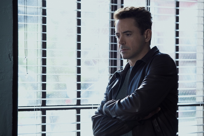 Robert Downey Jr. in front of blinds