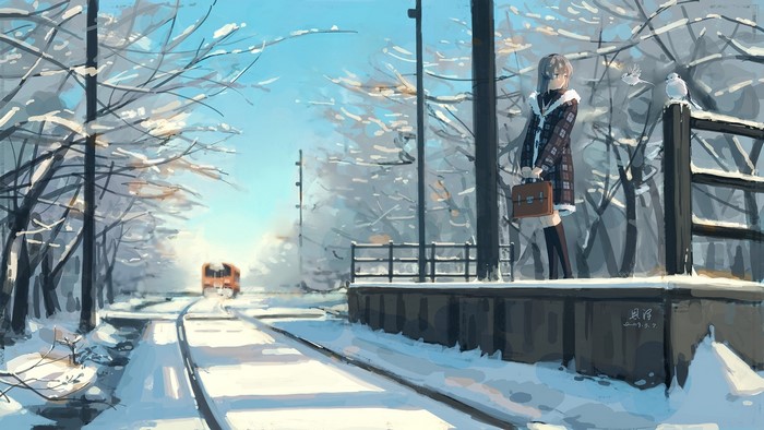 Girl waiting at a snowy train station