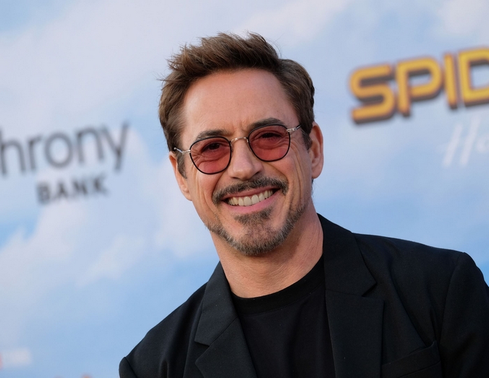 Robert Downey Jr. smiles wearing sunglasses
