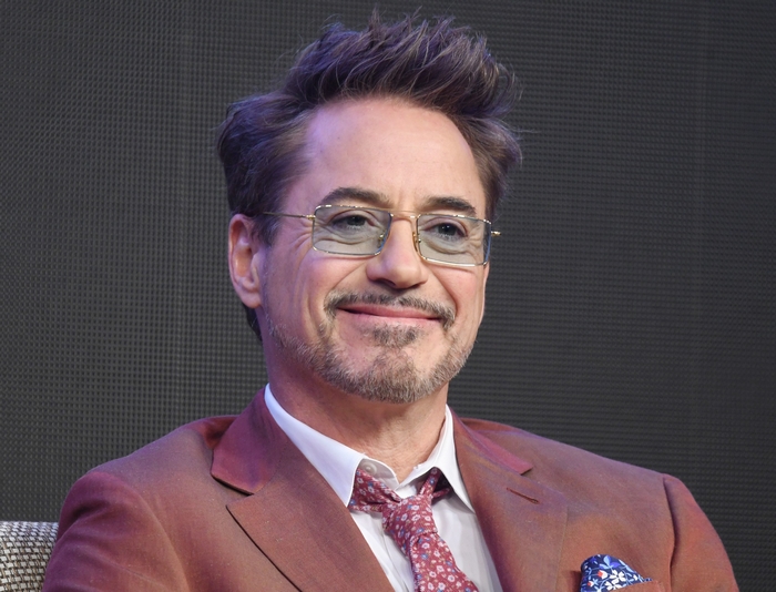 Robert Downey Jr. wearing glasses and a suit