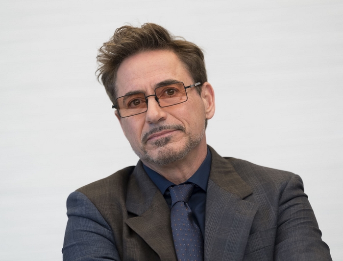 Robert Downey Jr. wearing glasses and a suit