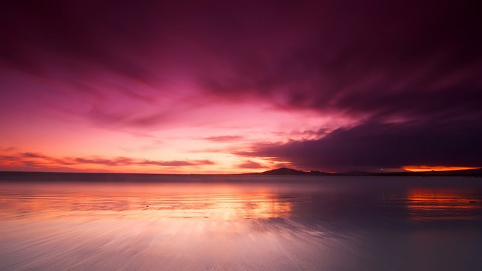 Sunset over the Pacific Ocean with mountains