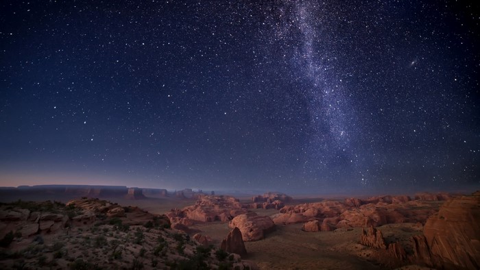 Monument Valley at night with the Milky Way galaxy