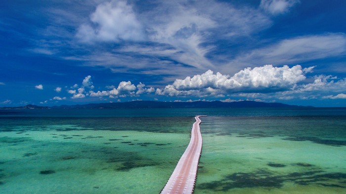 A long white bridge over turquoise water in Thailand