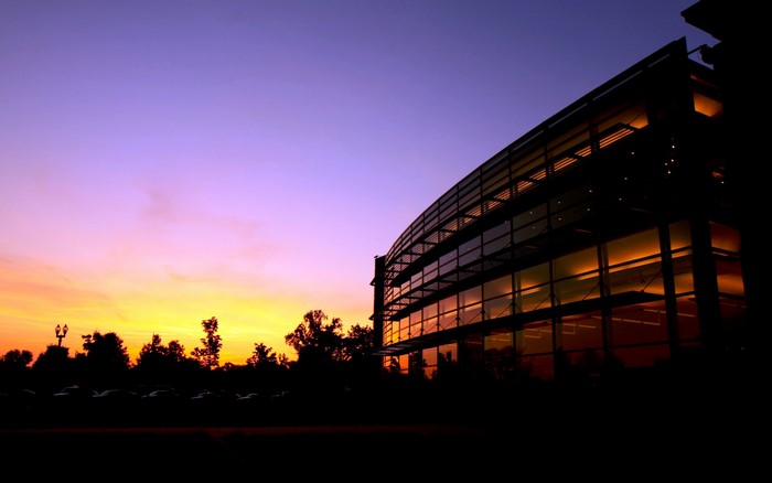 Modern building at sunset with purple and orange sky