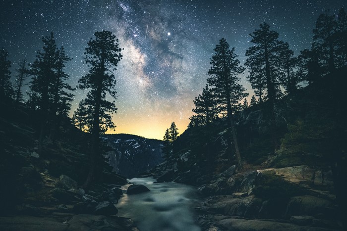 Milky Way over a river and trees