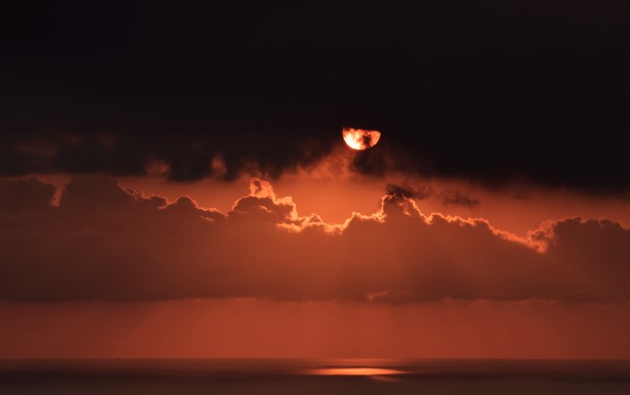 Sunset over the ocean with clouds