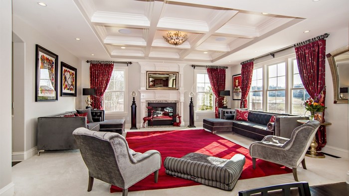 Luxury living room with red rug and fireplace