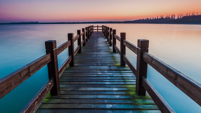 Wooden pier on a lake at sunset