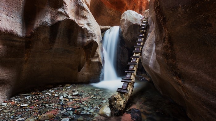 Ladder next to waterfall in Kanarraville Falls canyon, Utah