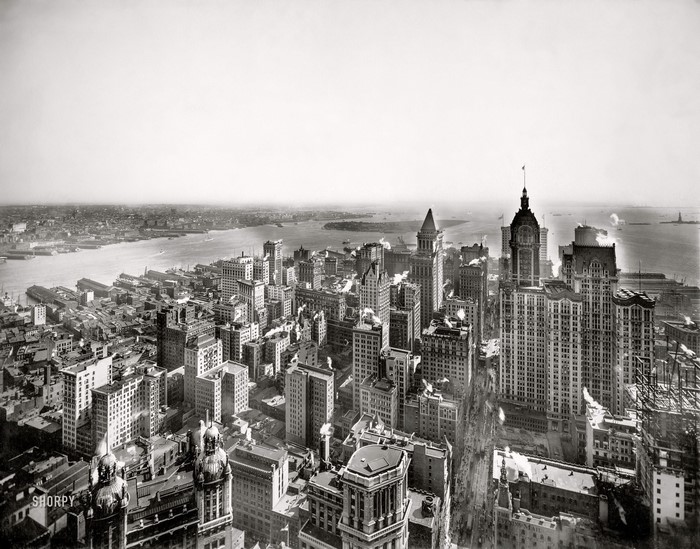 Aerial view of Manhattan cityscape with Statue of Liberty in distance