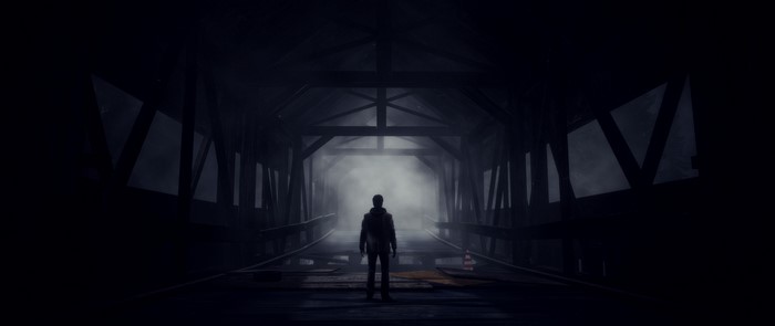 Alan Wake in a dark, foggy bridge