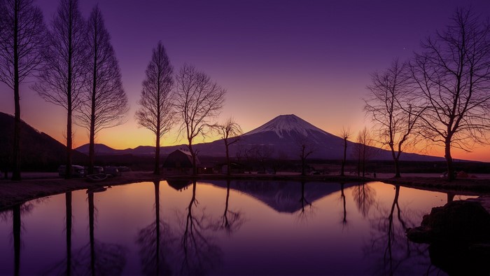 Mount Fuji reflection at sunset with trees and pond